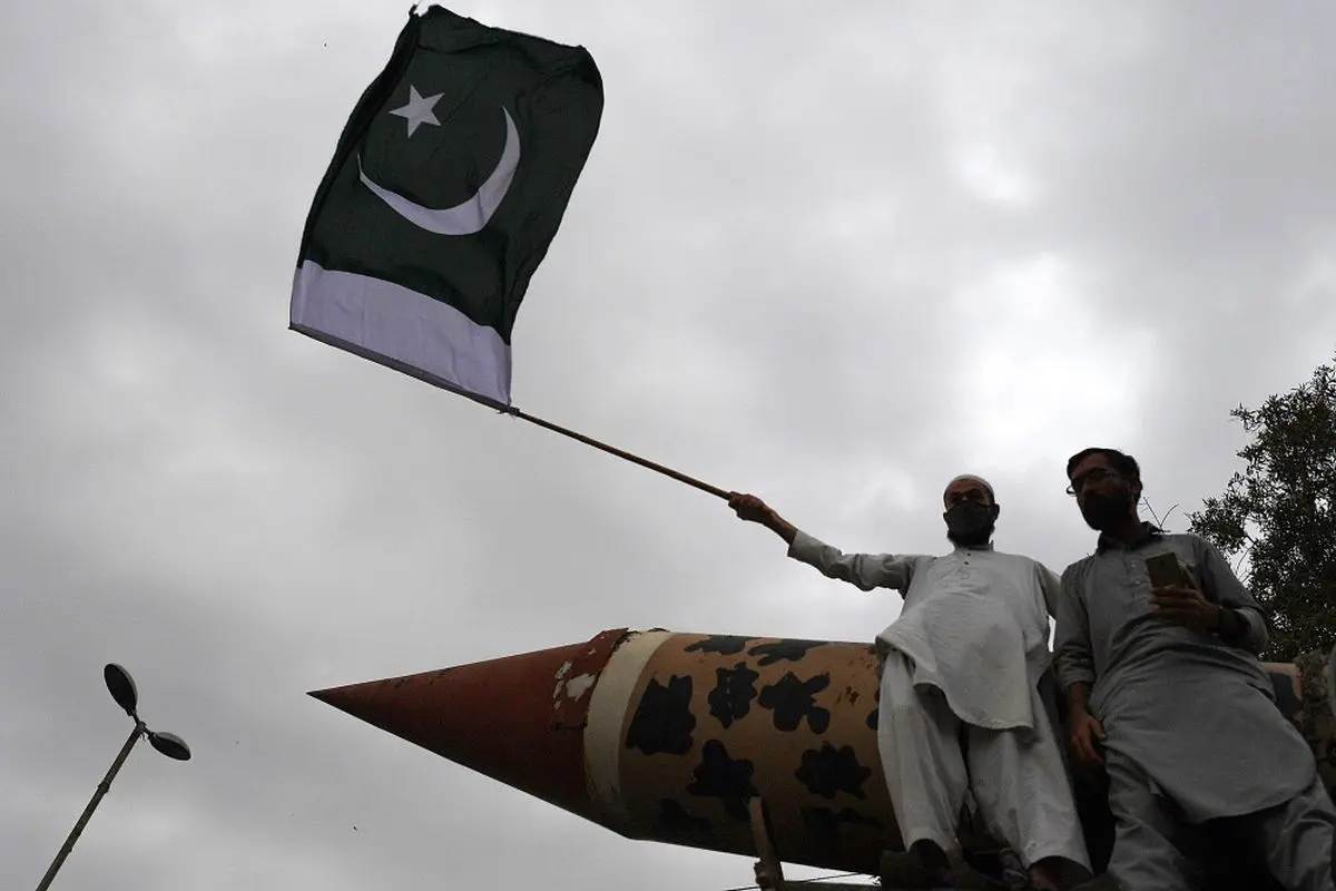 File photo shows a supporter of the Jamaat-e-Islami (JI) party holds a Pakistan's national flag along with a replica of a nuclear missile during an anti-India protest rally in Karachi