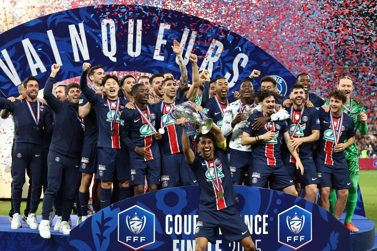 Paris Saint-Germain team members celebrate after winning French Cup final football match between Paris Saint-Germain (PSG) and Stade de Reims at the Stade de France in Saint-Denis, north of Paris, on May 24, 2025. | Photo:  AFP