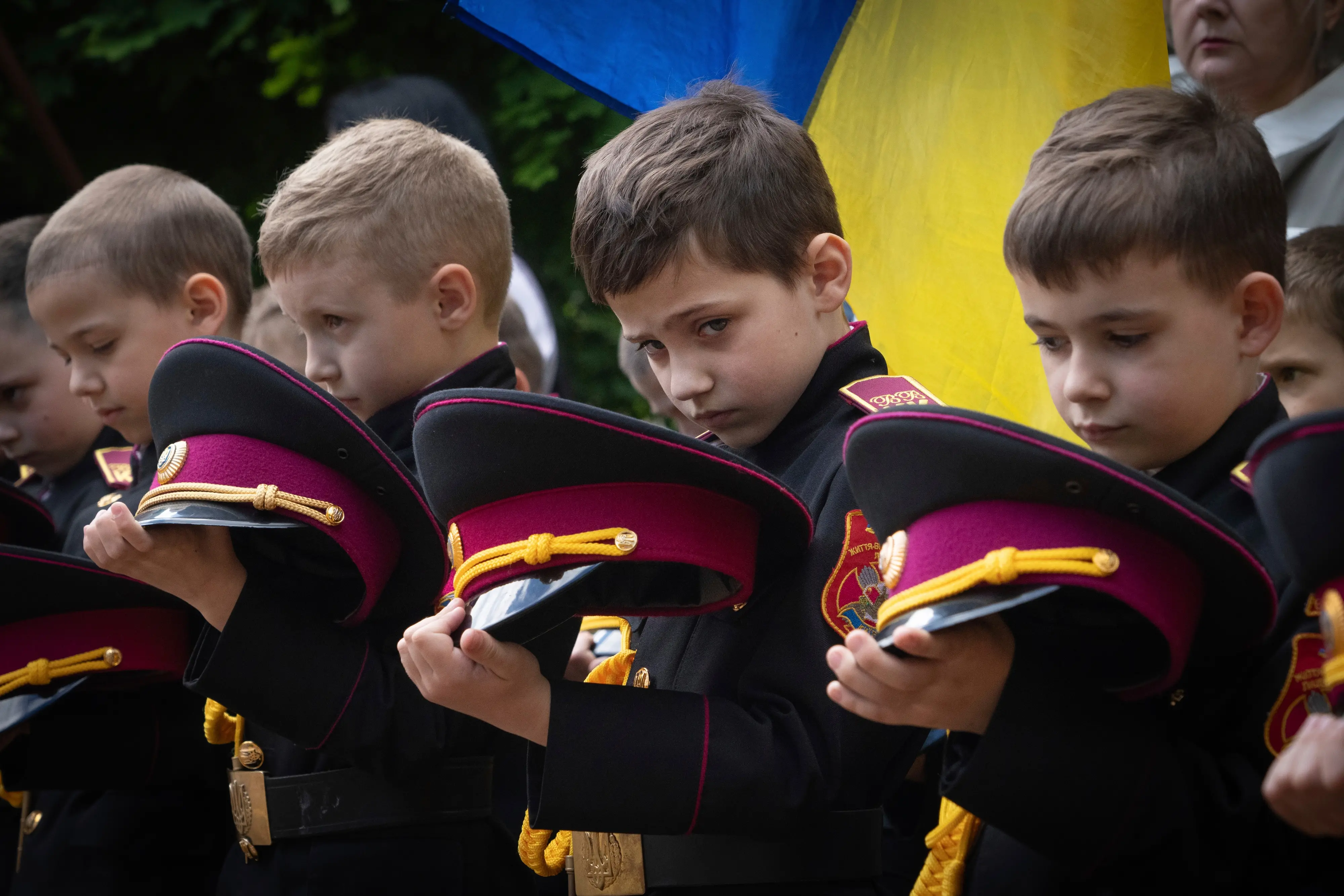 Young cadets hold a moment of silence to commemorate graduates killed in Russia-Ukraine war during a graduation ceremony at the cadet lyceum in Kyiv, Ukraine. | Photo: AP