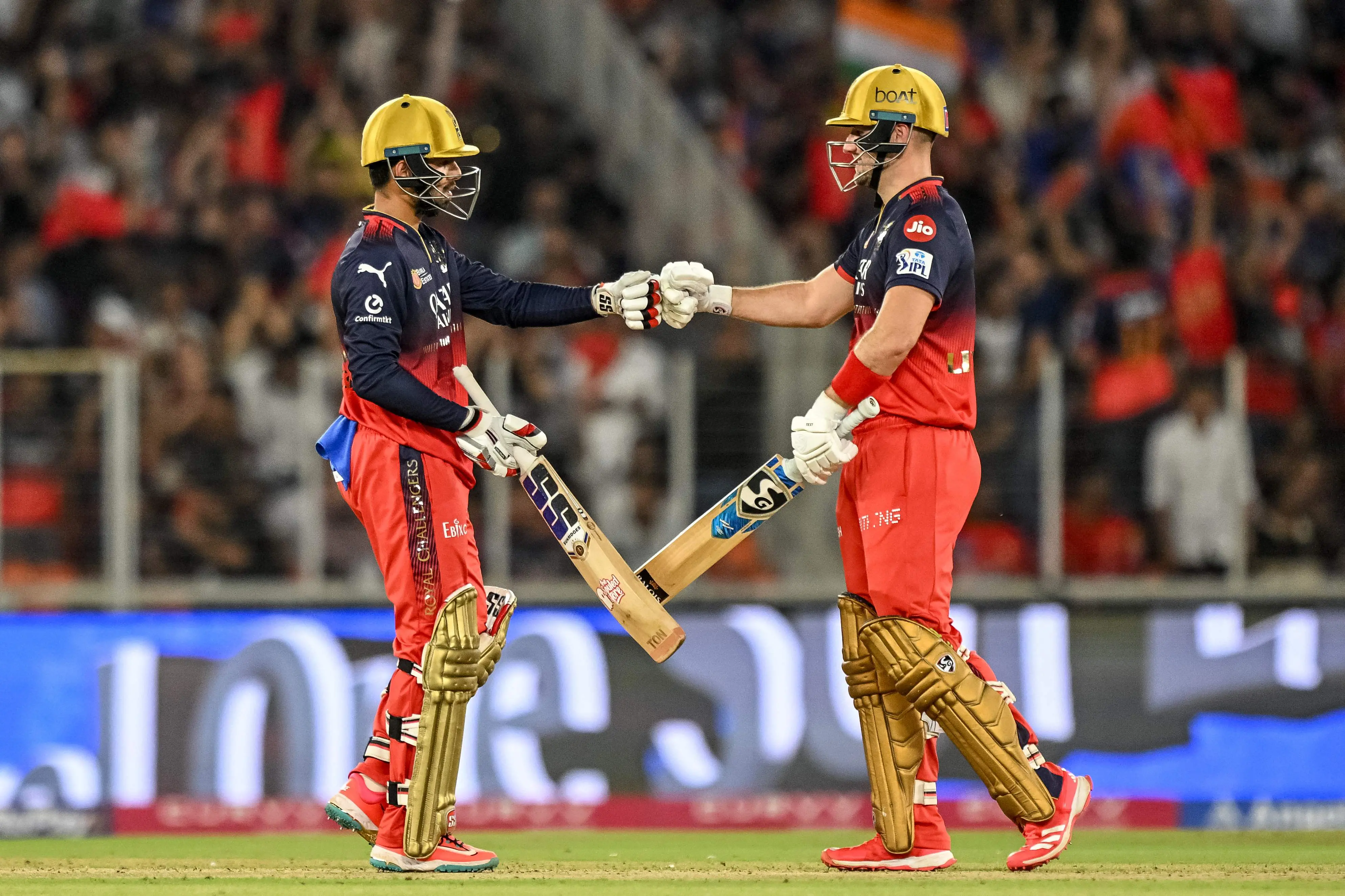 Royal Challengers Bengaluru's Jitesh Sharma (L) and Liam Livingstone bump their fists during the IPL final between Royal Challengers Bengaluru and Punjab Kings at the Narendra Modi Stadium | Photo: AFP