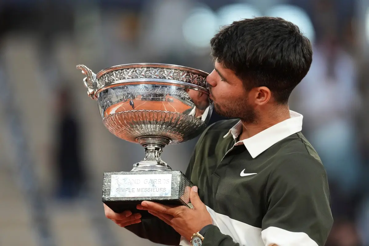 Spain's Carlos Alcaraz celebrates with the trophy after winning the final match of the French Tennis Open against Italy's Jannik Sinner at the Roland-Garros stadium in Paris. | Photo: AP