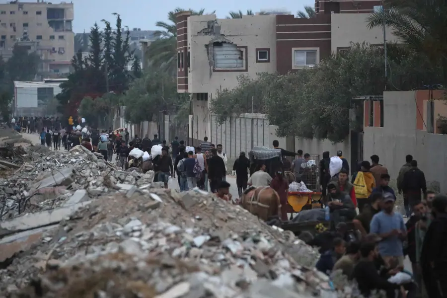 Palestinians carry humanitarian aid
