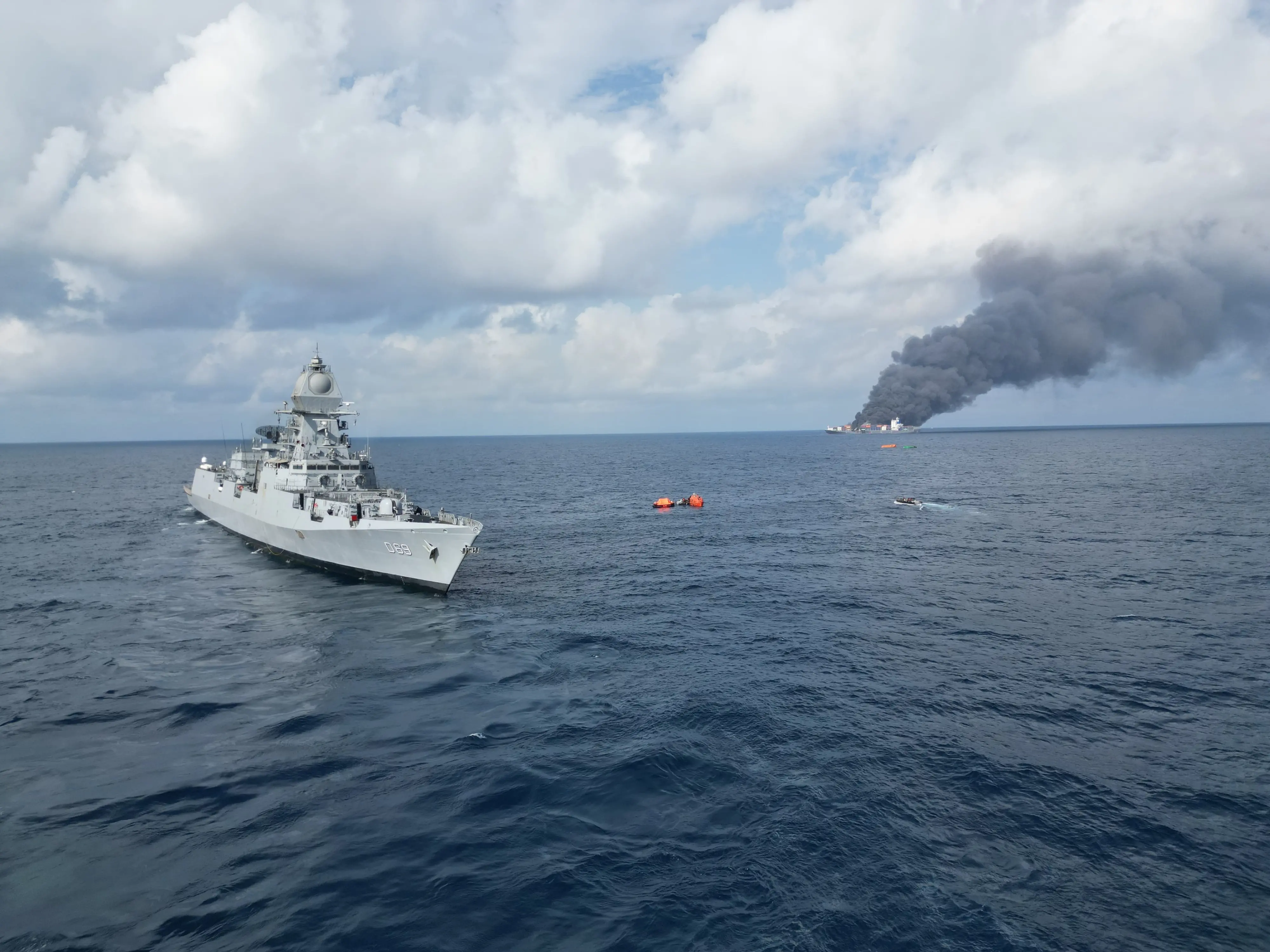 A handout photo shows an Indian Naval ship positioned near the cargo vessel that caught fire off the Kerala coast.