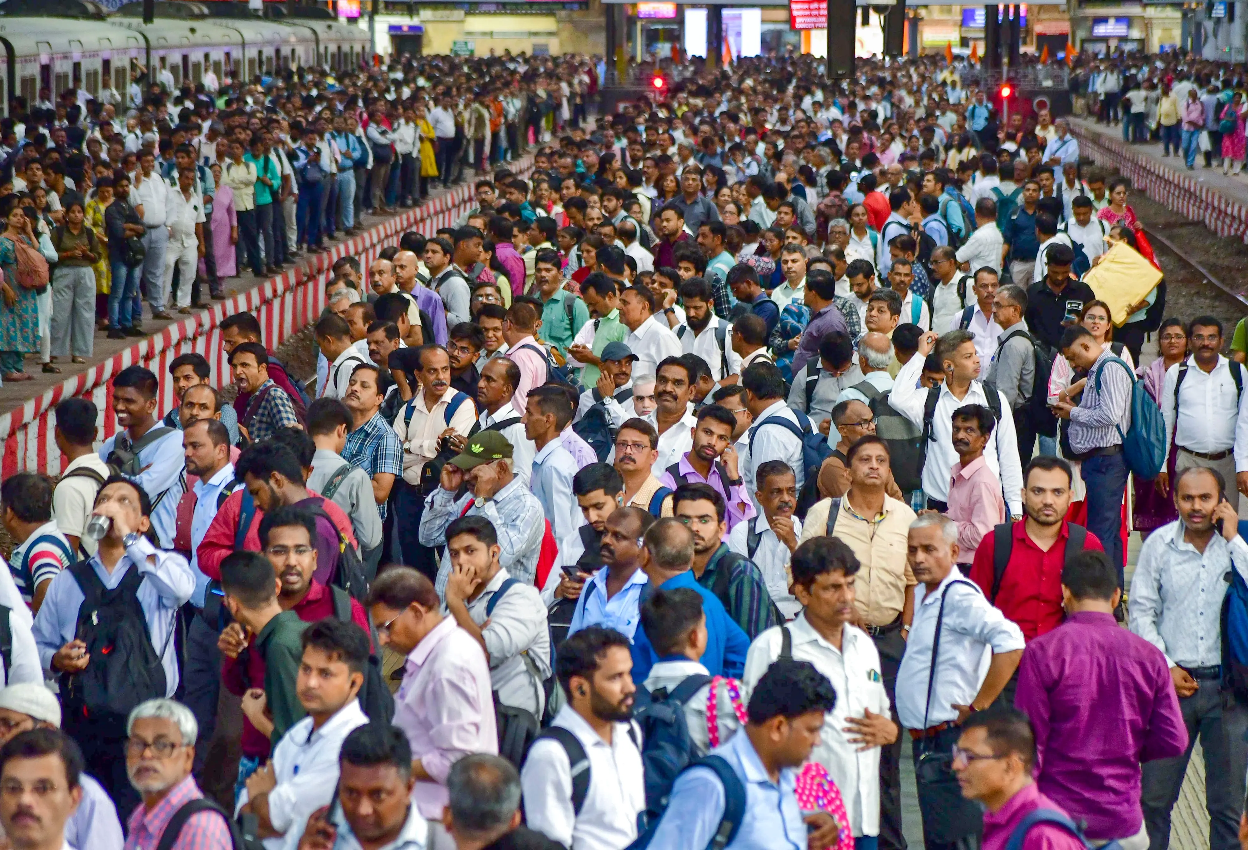Passengers wait to board local trains amid a massive rush at CSMT, in Mumbai | PTI Photo