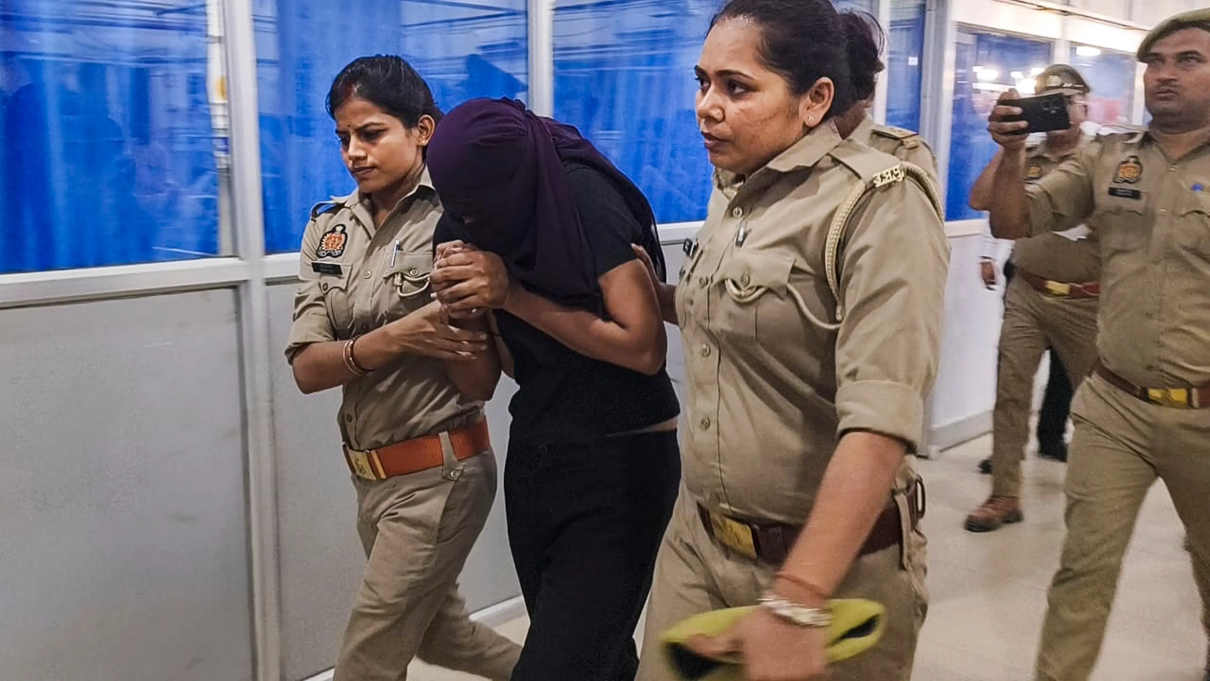 Sonam Raghuvanshi, the Indore woman accused of plotting her husband's murder during their honeymoon in Meghalaya, being brought for medical examination at a hospital, in Ghazipur. | Photo: PTI