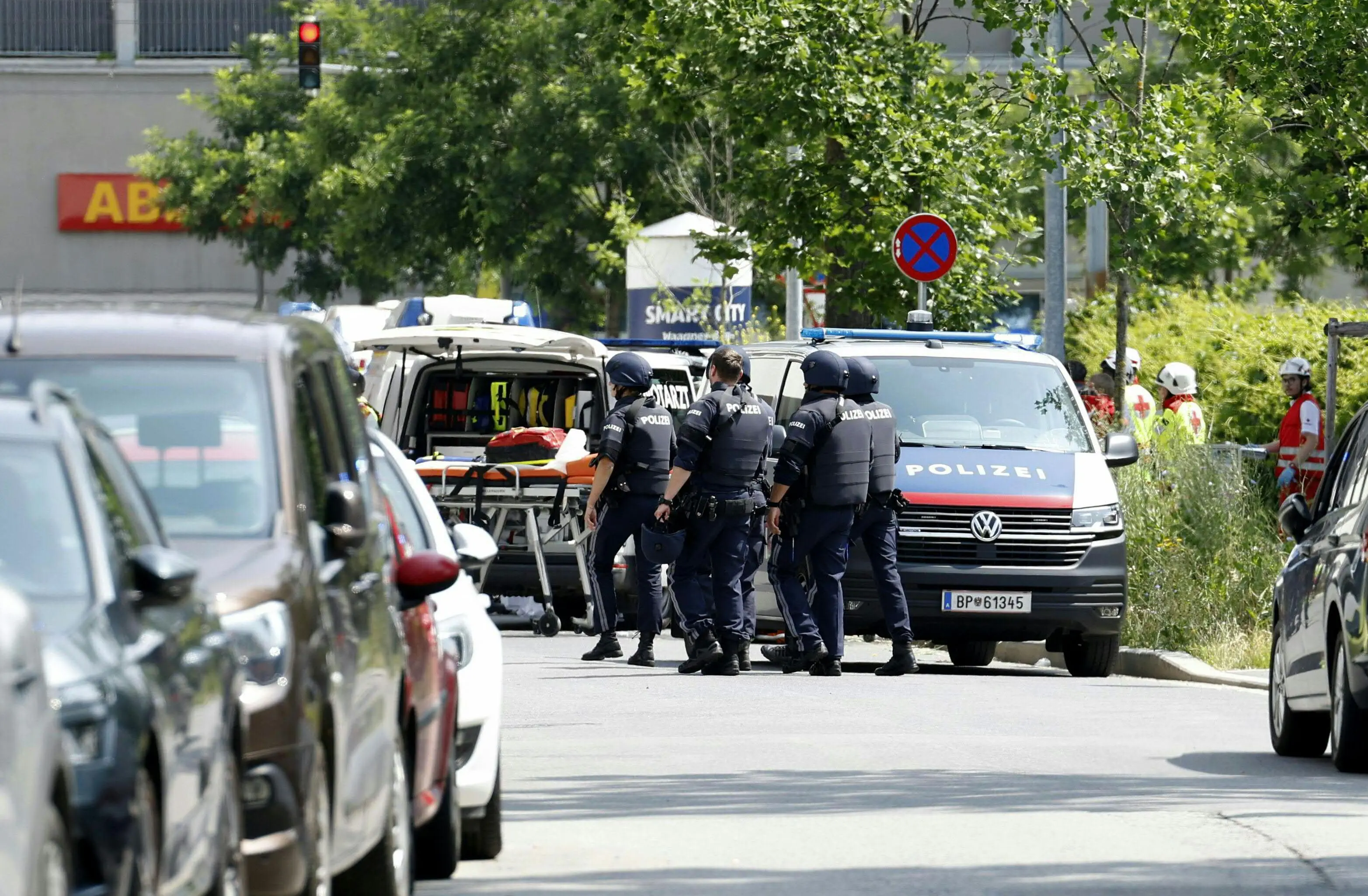 Policemen are seen in a street close to a school where, according to reports, several people died in a shooting | AFP