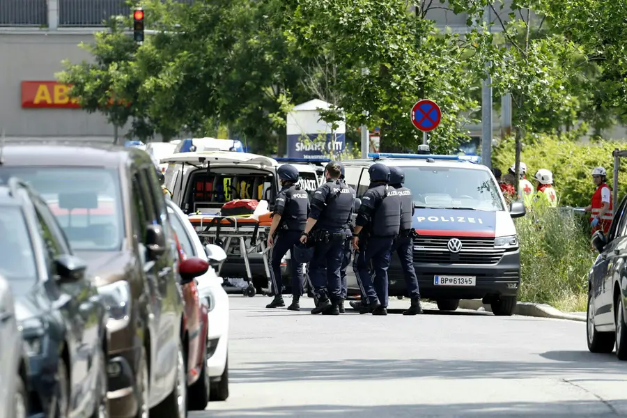 Policemen are seen in a street close to a school where, according to reports, several people died in a shooting