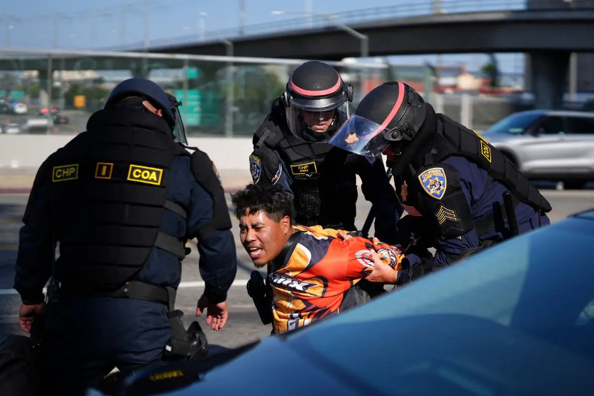 A protester is arrested by California Highway Patrol near the federal building in downtown Los Angeles (Photo: AP)