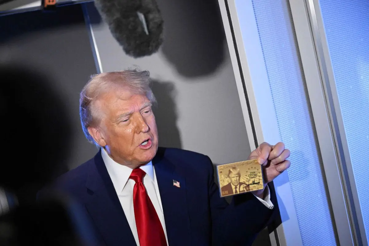 US President Donald Trump holds the $5 million dollar Gold Card as he speaks to reporters while in flight on board Air Force One (Photo: AFP)