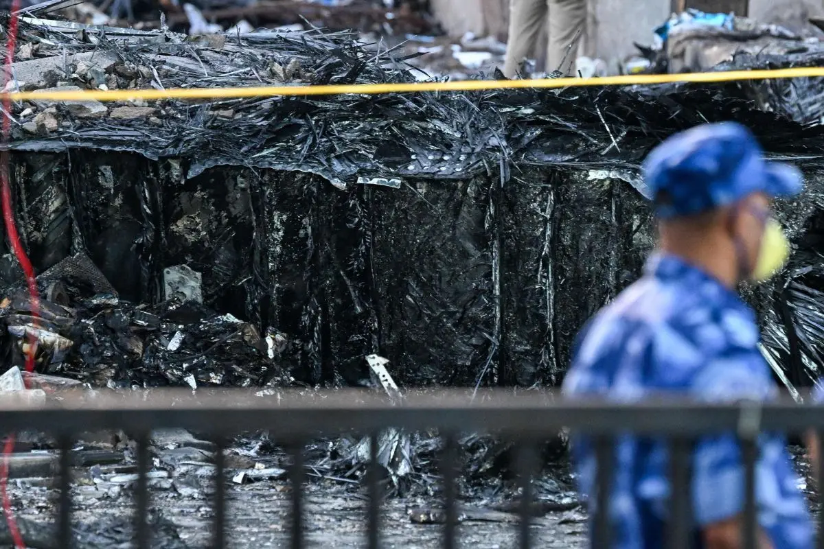 Police stand guard near wreckage at the site after Air India flight 171 crashed in a residential area near the airport in Ahmedabad (Photo: AFP)