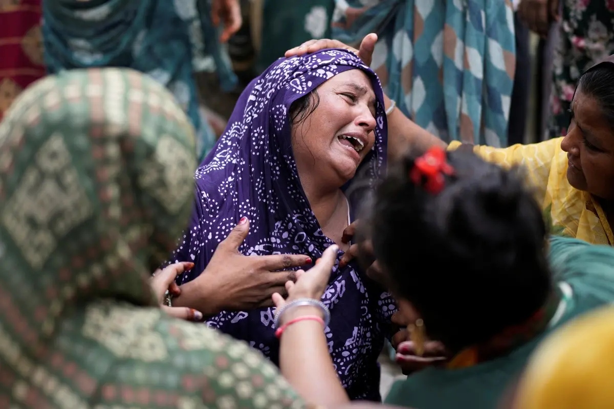 A relative of a victim of the Air India plane crash is comforted as she breaks down at a hospital | Photo: AP