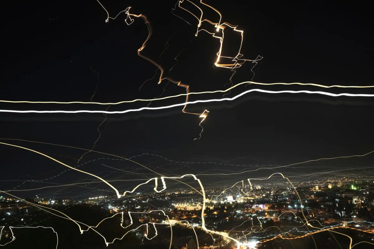 In this image taken with a slow shutter speed, projectiles light up the night sky over Jerusalem during an Iranian missile attack (Photo: AP)
