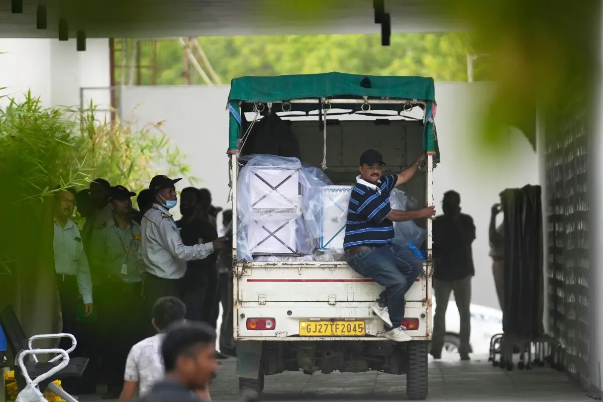 Caskets to carry the remains of some of the victims of Air India plane crash are brought in a vehicle to a hospital | Photo: AP