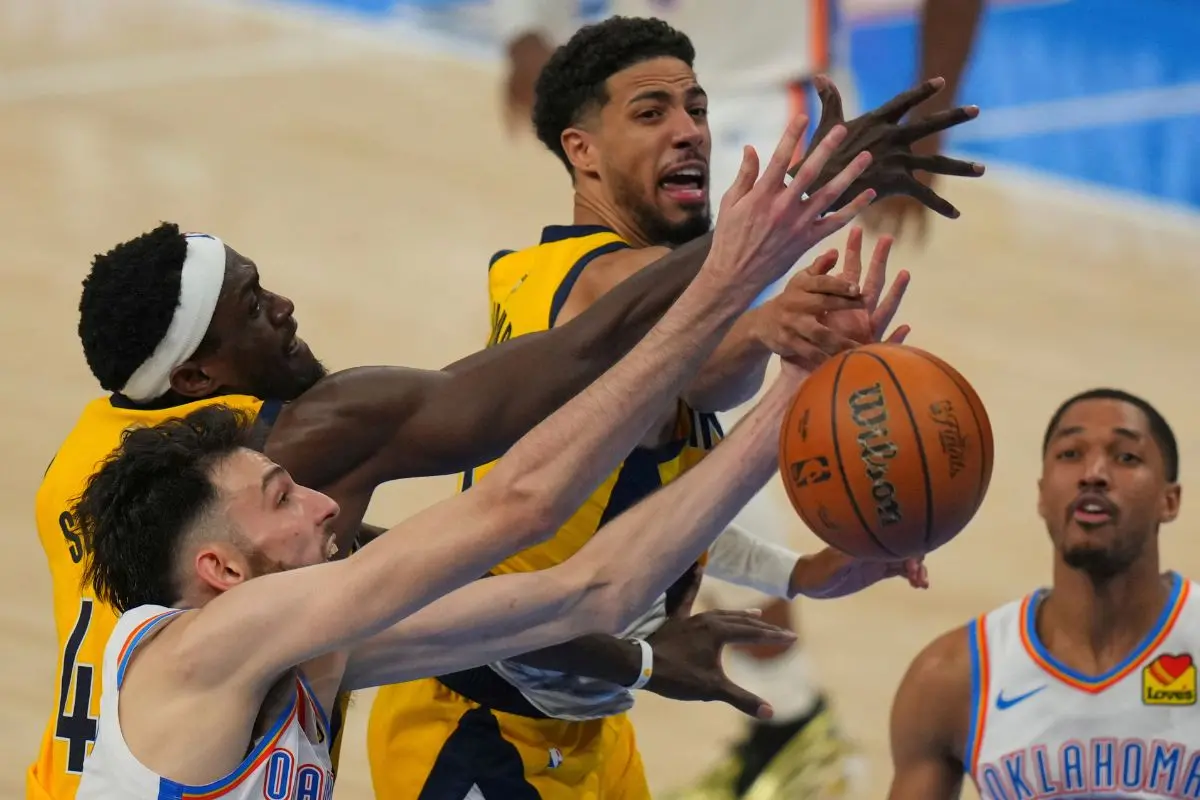 Indiana Pacers forward Pascal Siakam, Oklahoma City Thunder forward Chet Holmgren, left, and Indiana Pacers guard Tyrese Haliburton, center, battle for the rebound during the second half of Game 5 | AP