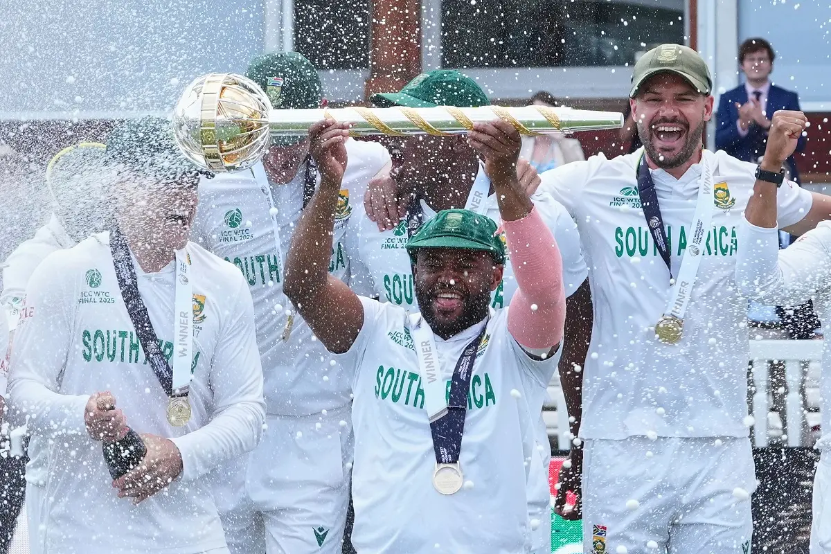 South Africa's captain Temba Bavuma holds the winner's trophy and celebrates with teammates after their win in the World Test Championship final | Photo: AP