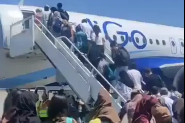 A screengrab from a video showing students boarding a flight to India