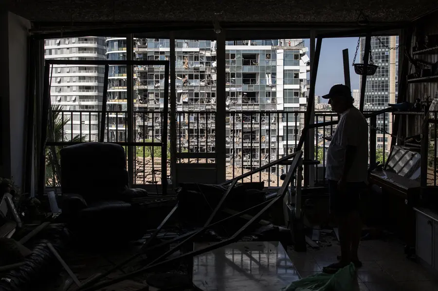 A man inspects a damaged house, a day after an Iranian missile struck an area in Ramat Gan in central Israel near Tel Aviv | AFP