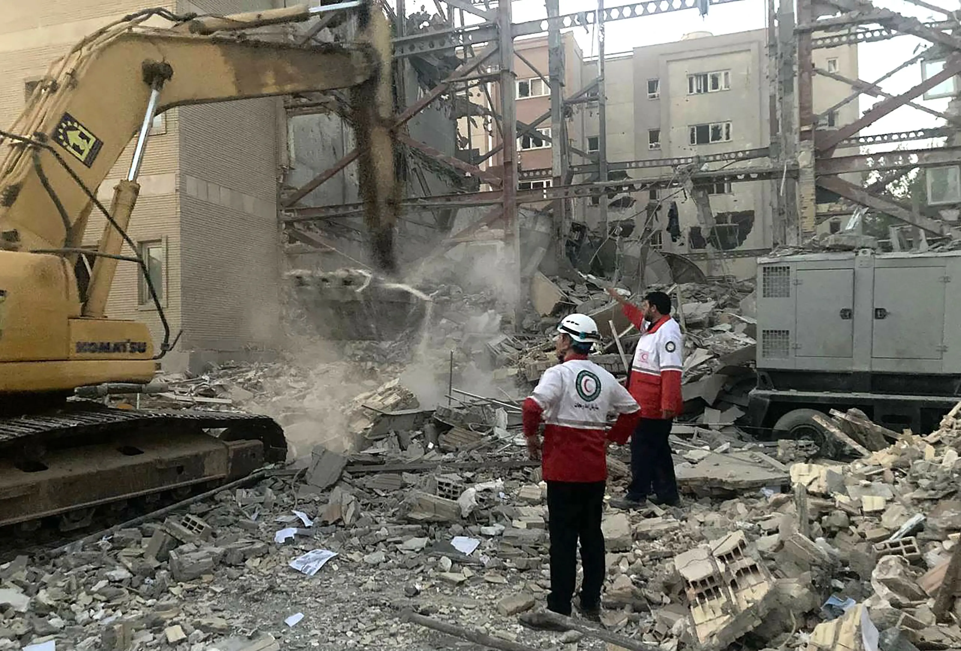Iranian Red Crescent members clearing debris at a building destroyed during an Israeli attack | AFP