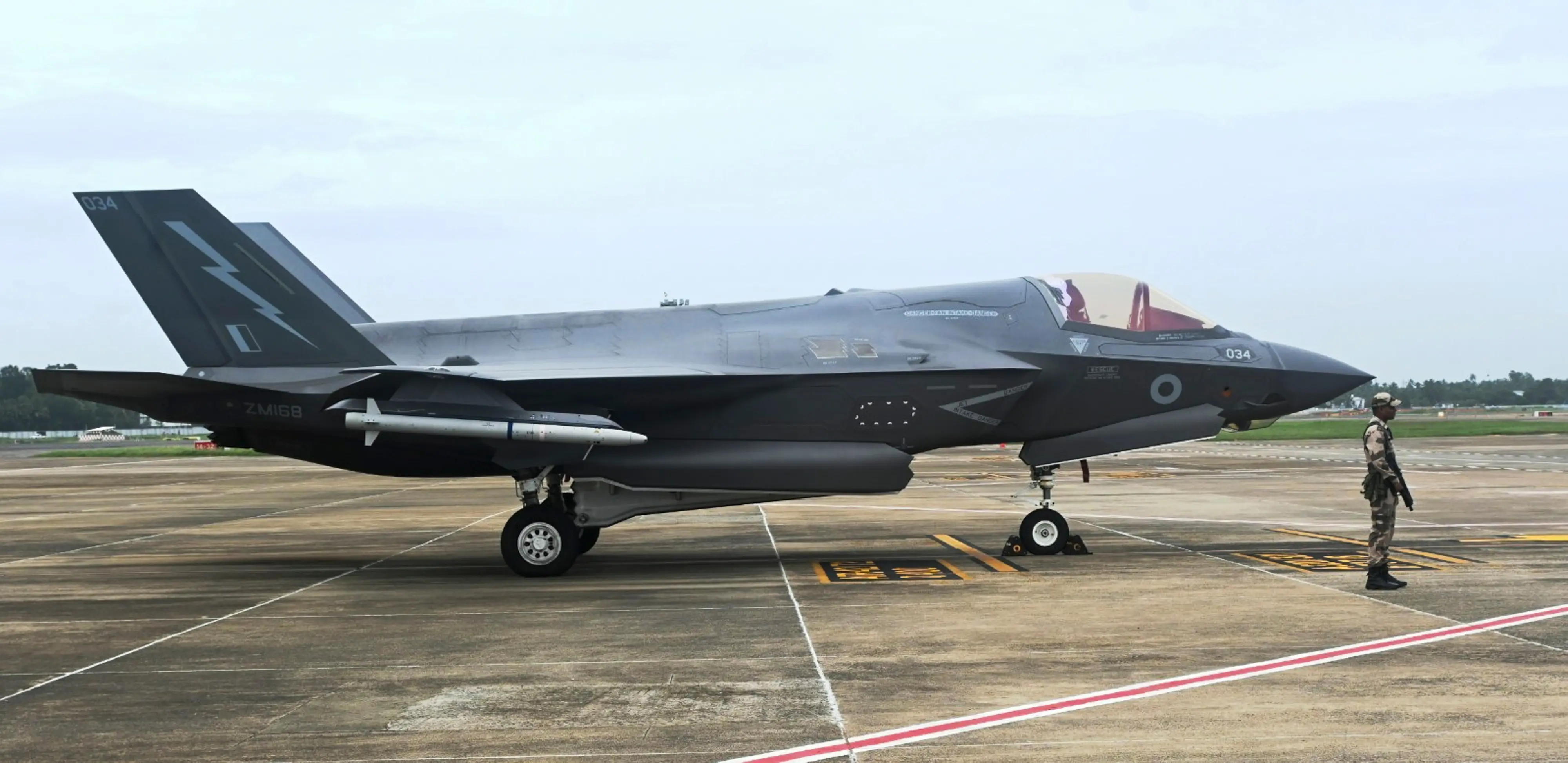 A CISF personnel stand guard near the British F-35 fighter jet that made an emergency landing | PTI
