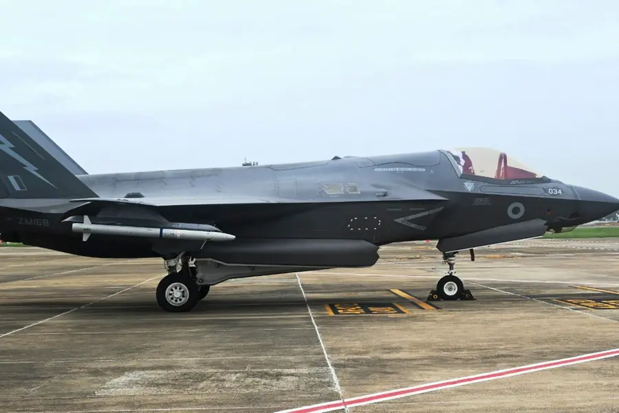 A CISF personnel stand guard near the British F-35 fighter jet that made an emergency landing