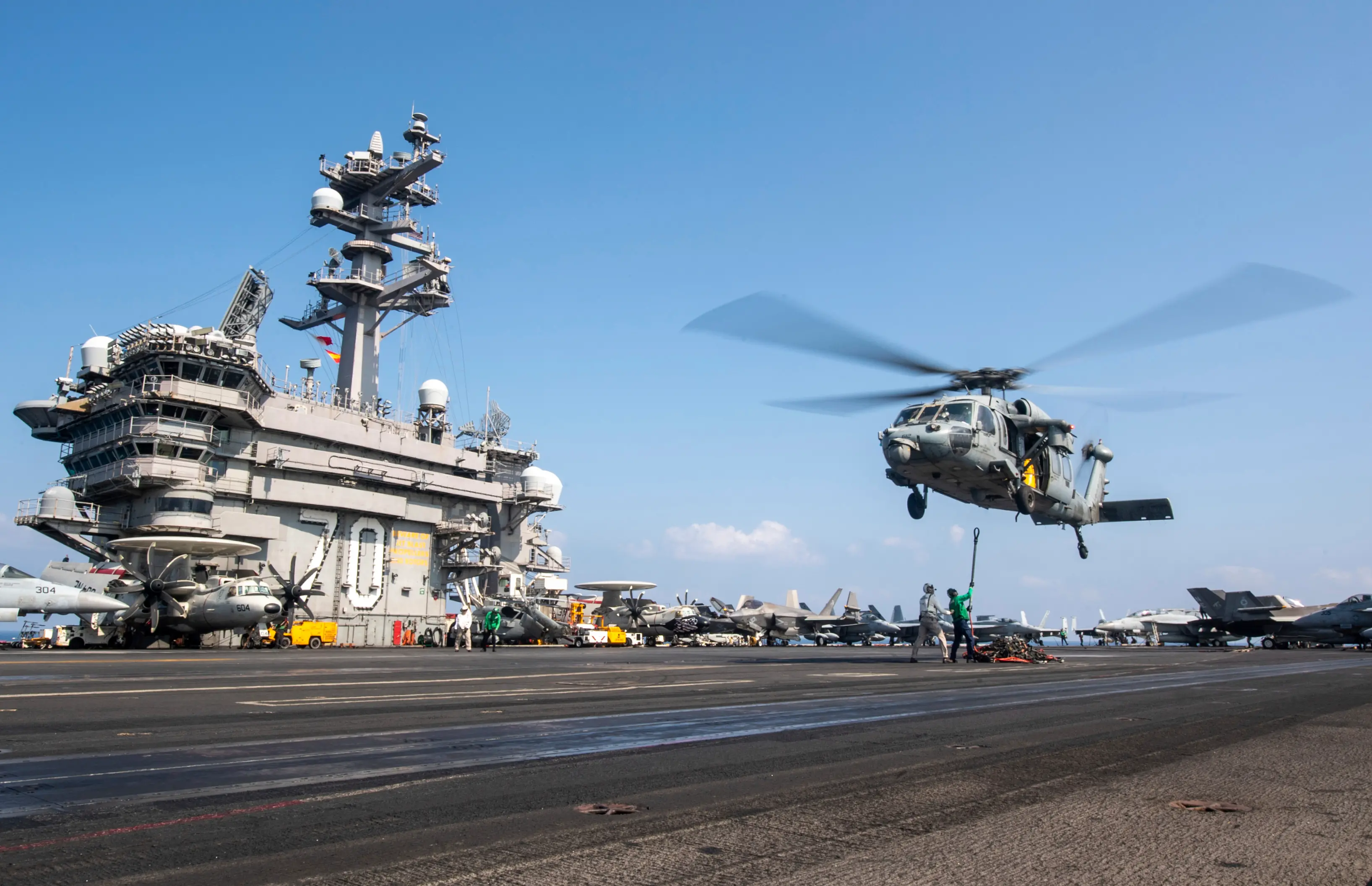 A MH-60S Sea Hawk helicopter hovering over the USS Carl Vinson aircraft carrier while operating in the Middle East | AP