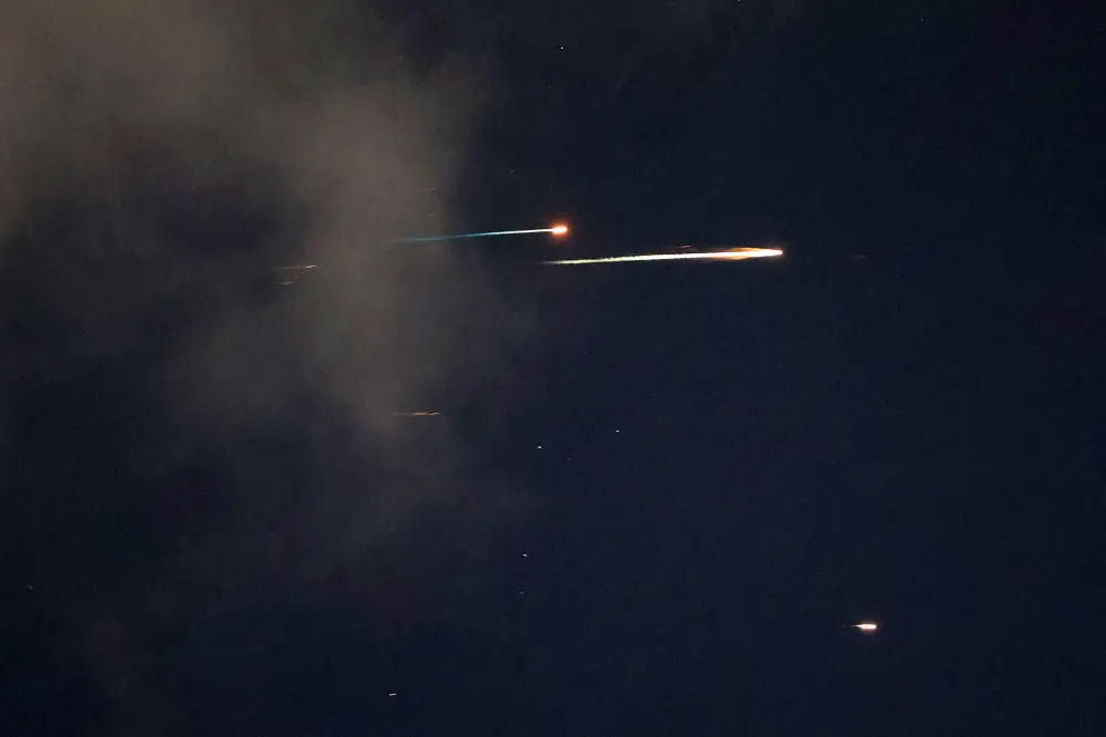 Rocket trails are seen in the sky above the Israeli coastal city of Netanya | AFP