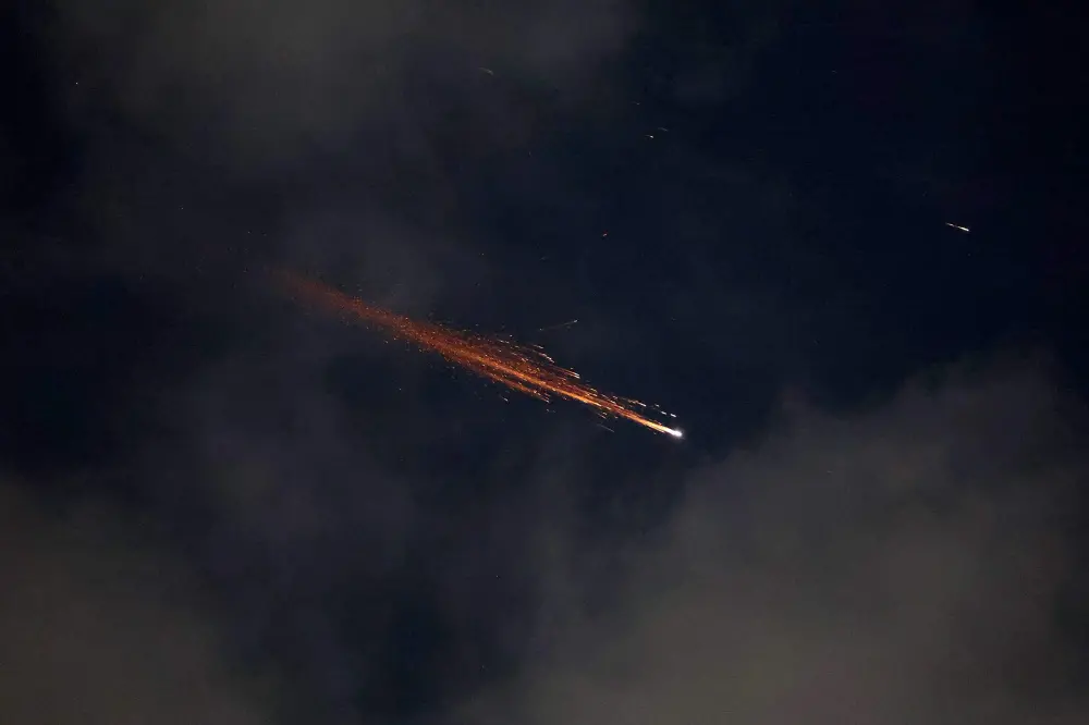 Rocket trails are seen in the sky above the Israeli coastal city of Netanya in June 21 | AFP