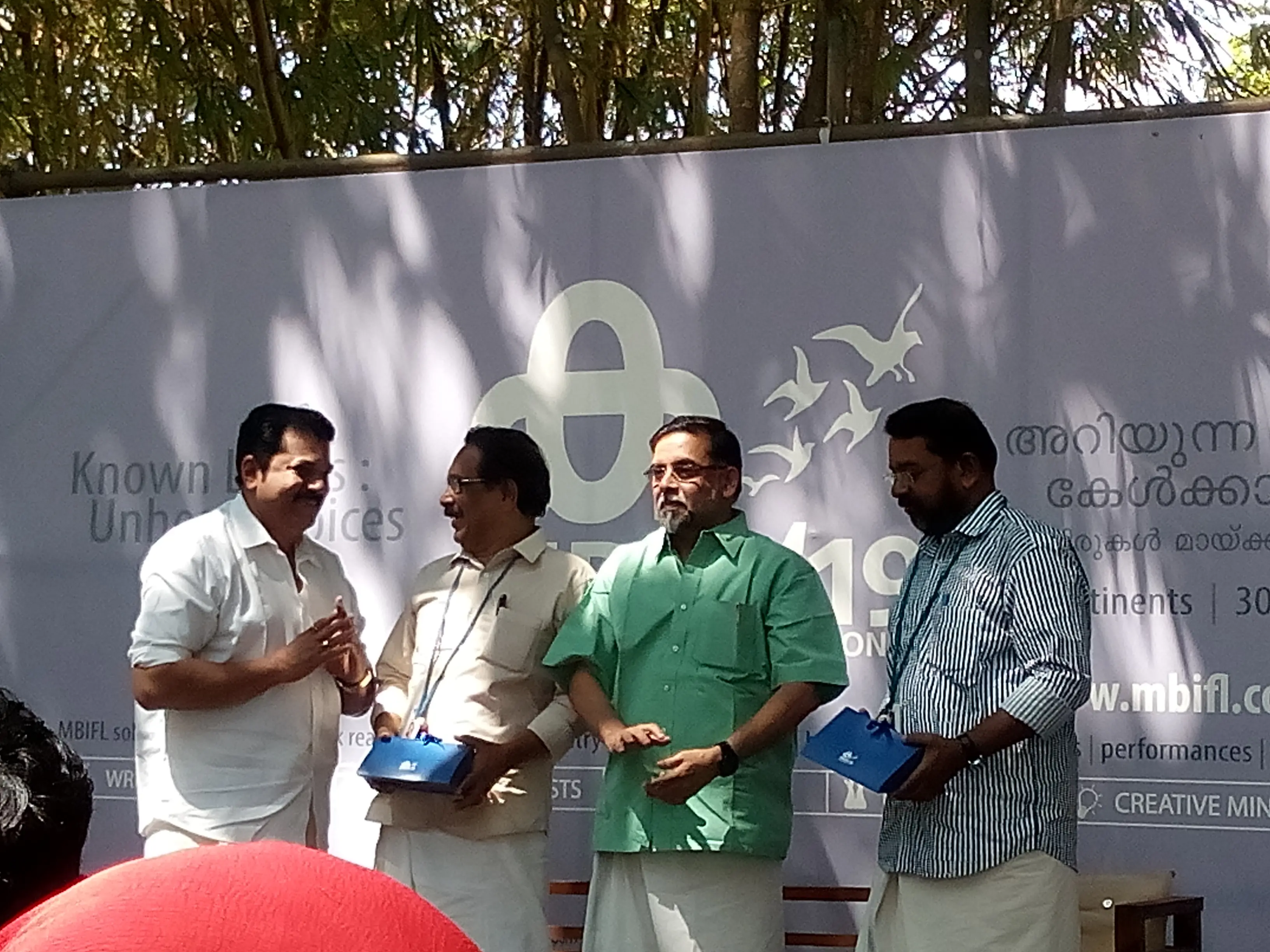 Actor Mukesh handing over presents to Alankode Leelakrishnan, Prabha Varma, KV Mohan Kumar