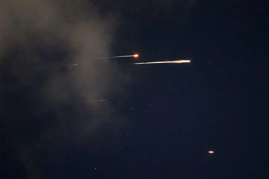 Rocket trails are seen in the sky above the Israeli coastal city of Netanya | AFP