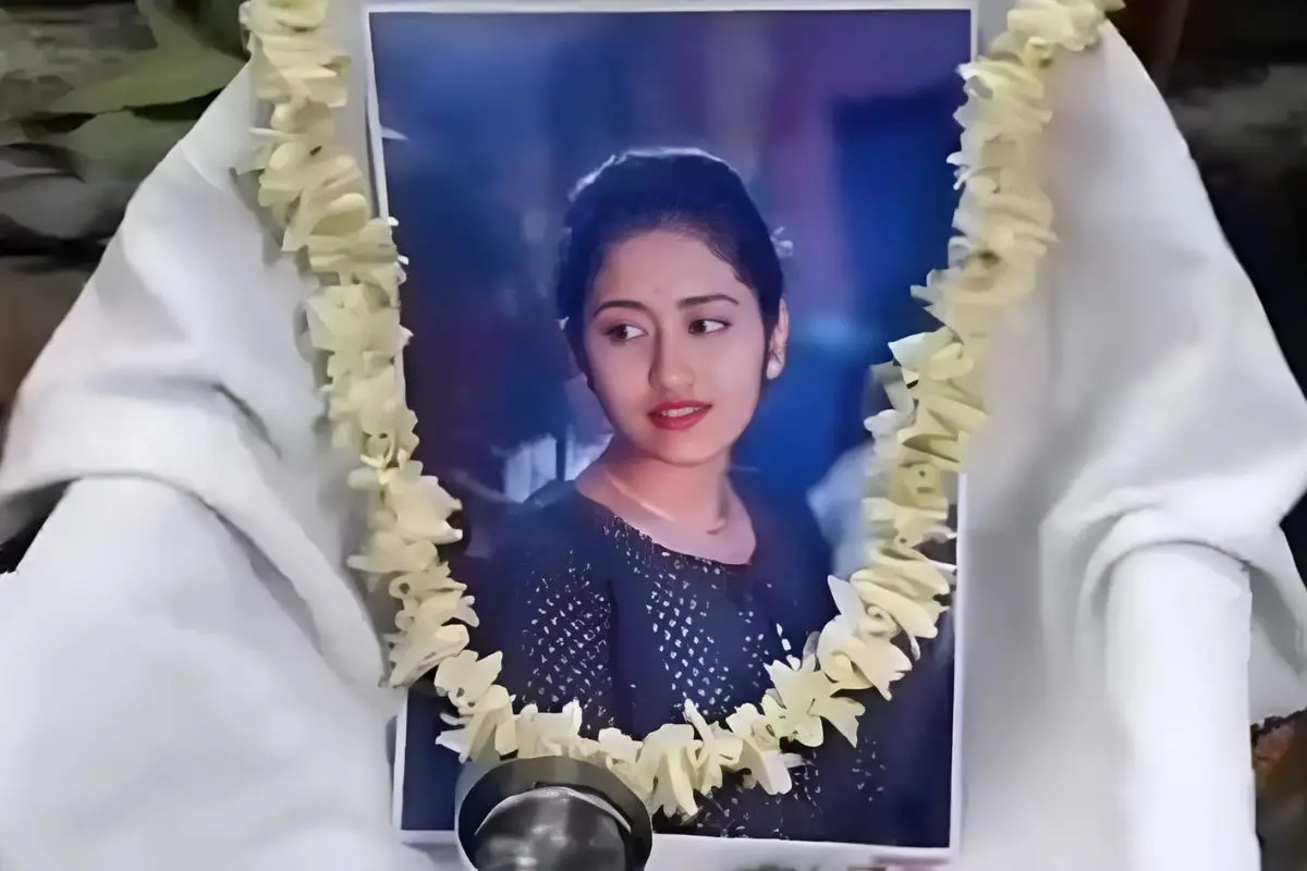 The girl's garlanded photo displayed by her family during the 'last rites' ceremony following her interfaith marriage.