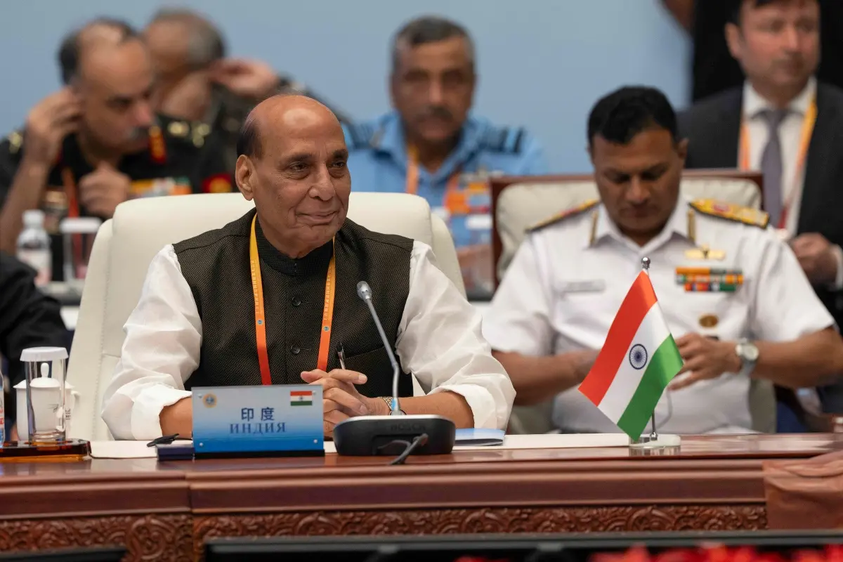 India's Defence Minister Rajnath Singh, left, attends the Defense Ministers' Meeting of the Shanghai Cooperation Organization Members States in Qingdao in eastern China's Shandong