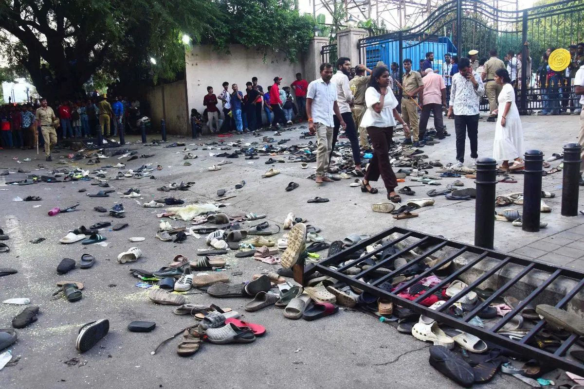 Fans stand next to abandonned shoes and a fallen barrier following a stampede during celebrations (Photo: AFP)