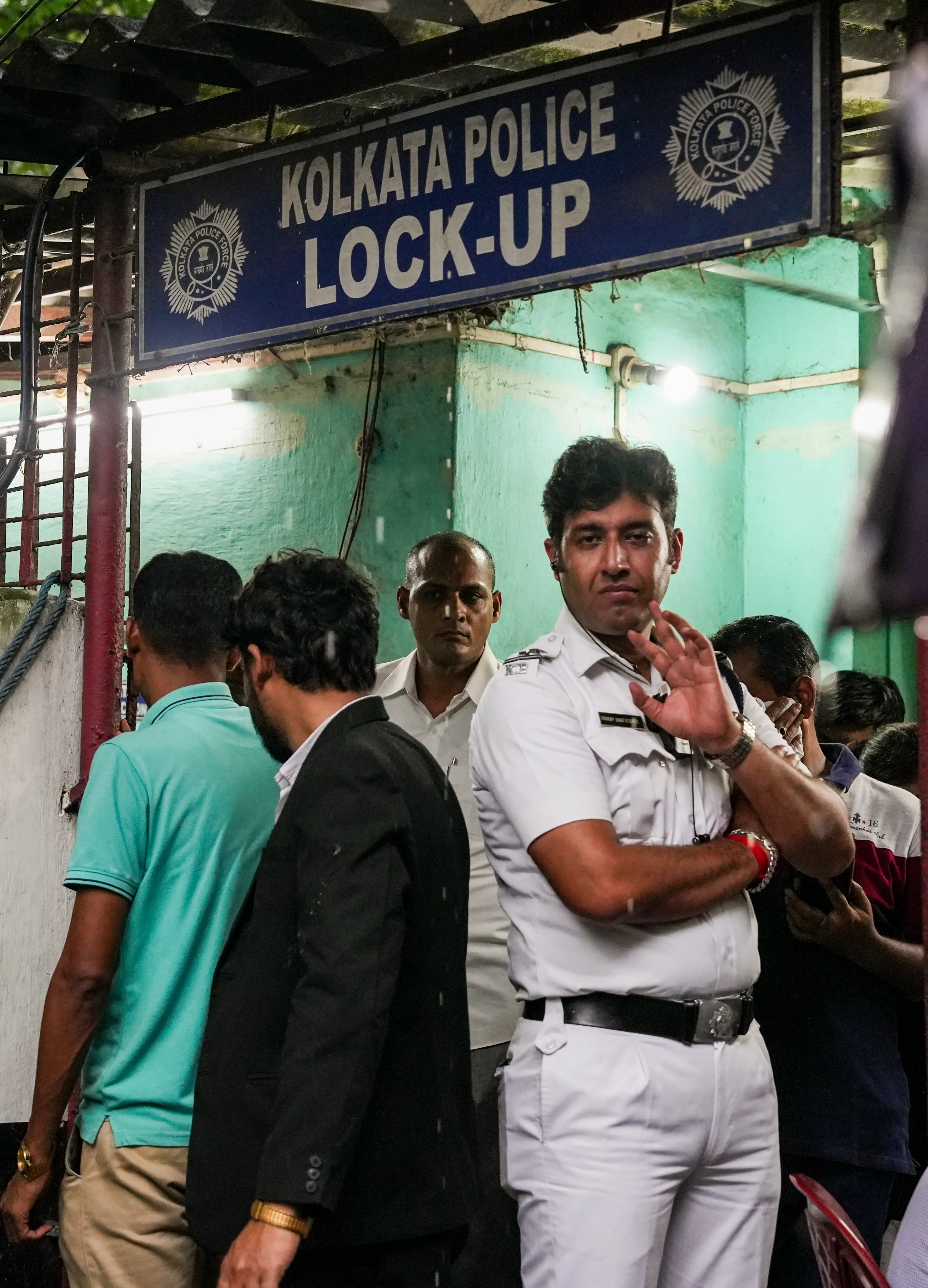 A police personnel stands guard outside a lock-up before the accused arrested in connection with the alleged gang rape of a student at a law college, are produced at Alipore Court, in Kolkata. | Photo: PTI