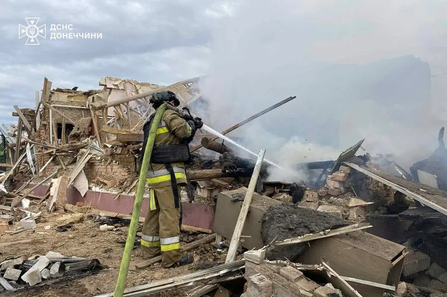 Emergency services personnel work to extinguish a fire following a Russian attack in Donetsk region, Ukraine