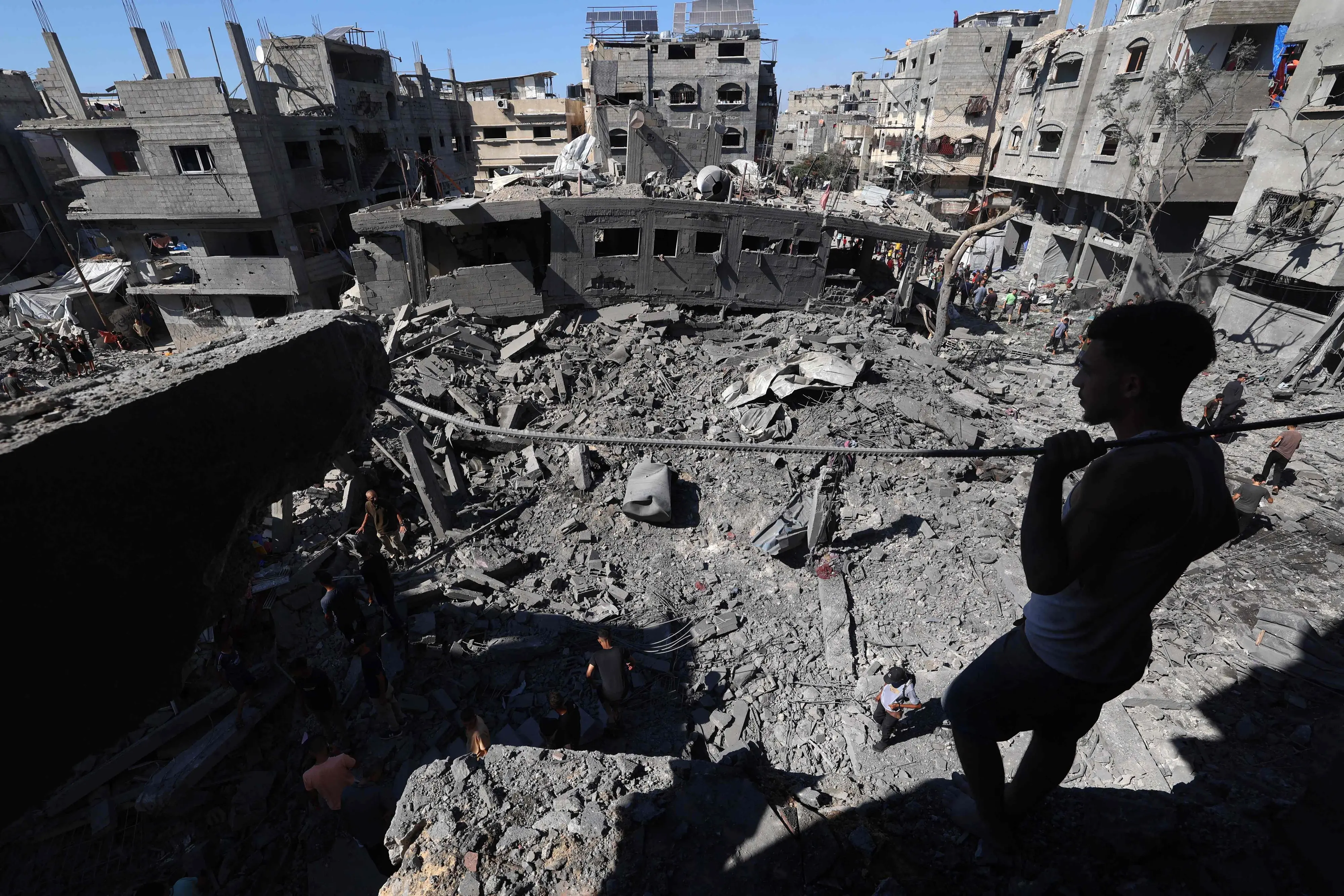 A Palestinian man inspects the damage after an Israeli strike in the Al-Bureij camp in the central Gaza Strip. | Photo: AFP