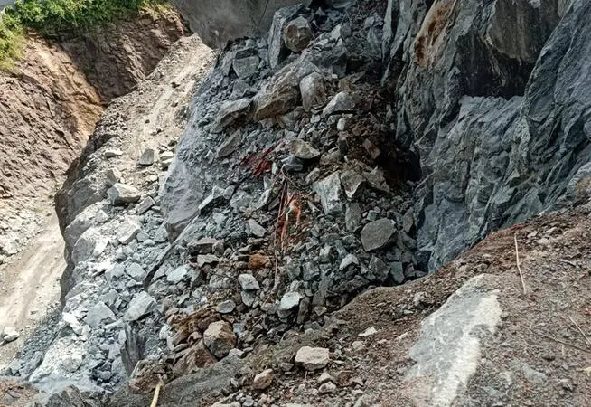 A visual of the Hitachi excavator buried under heavy rocks following the quarry rockfall in Konni | Mathrubhumi