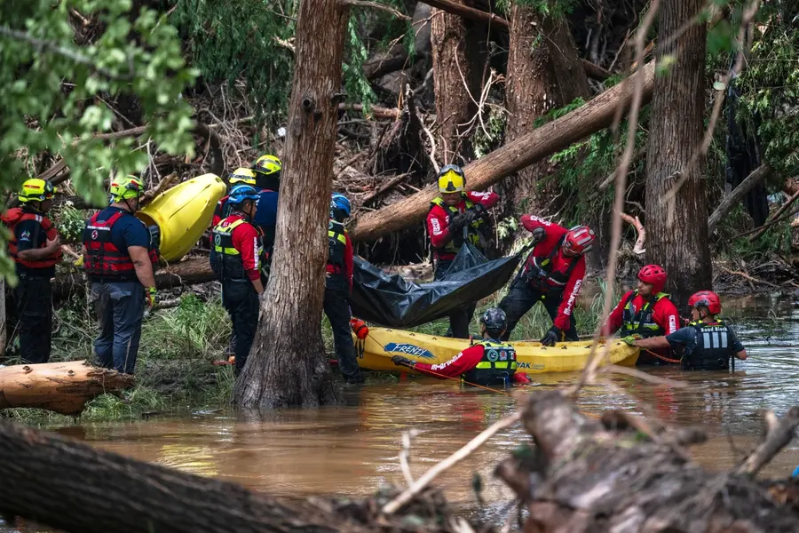 Firefighters load a body into a raft