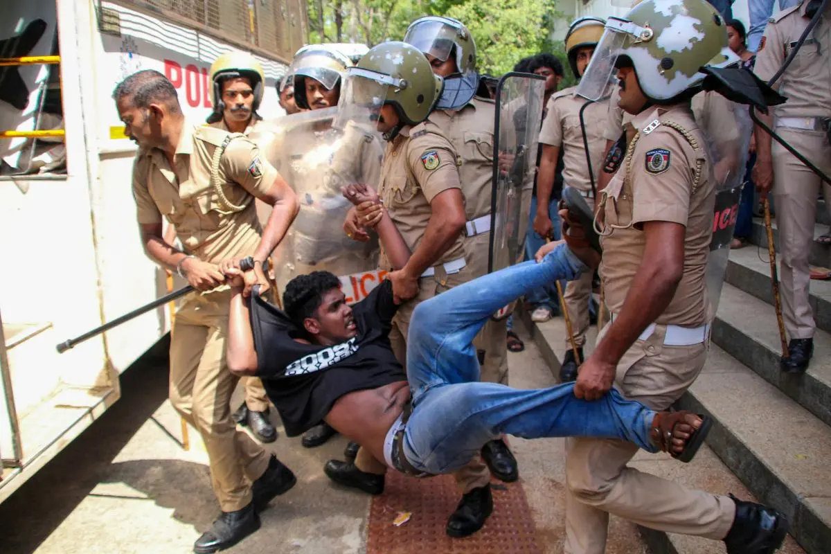 Police personnel detain a member of SFI during a protest against Kerala Governor Rajendra Arlekar, alleging saffronisation of state universities, at Kerala University | PTI