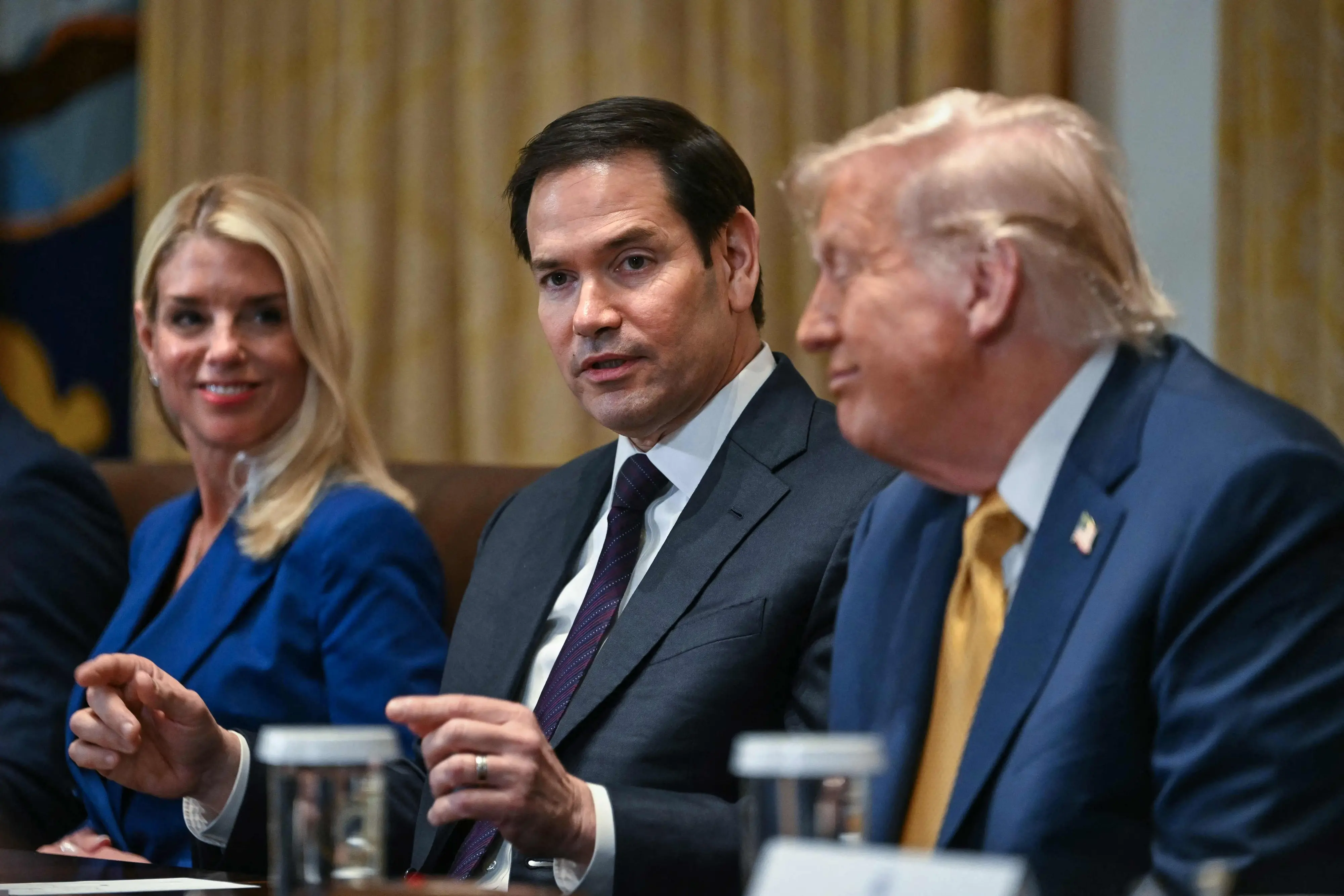US Secretary of State Marco Rubio (C) speaks as President Donald Trump and Attorney General Pam Bondi look on during a cabinet meeting in the Cabinet Room of the White House in Washington, DC. | Photo: AFP