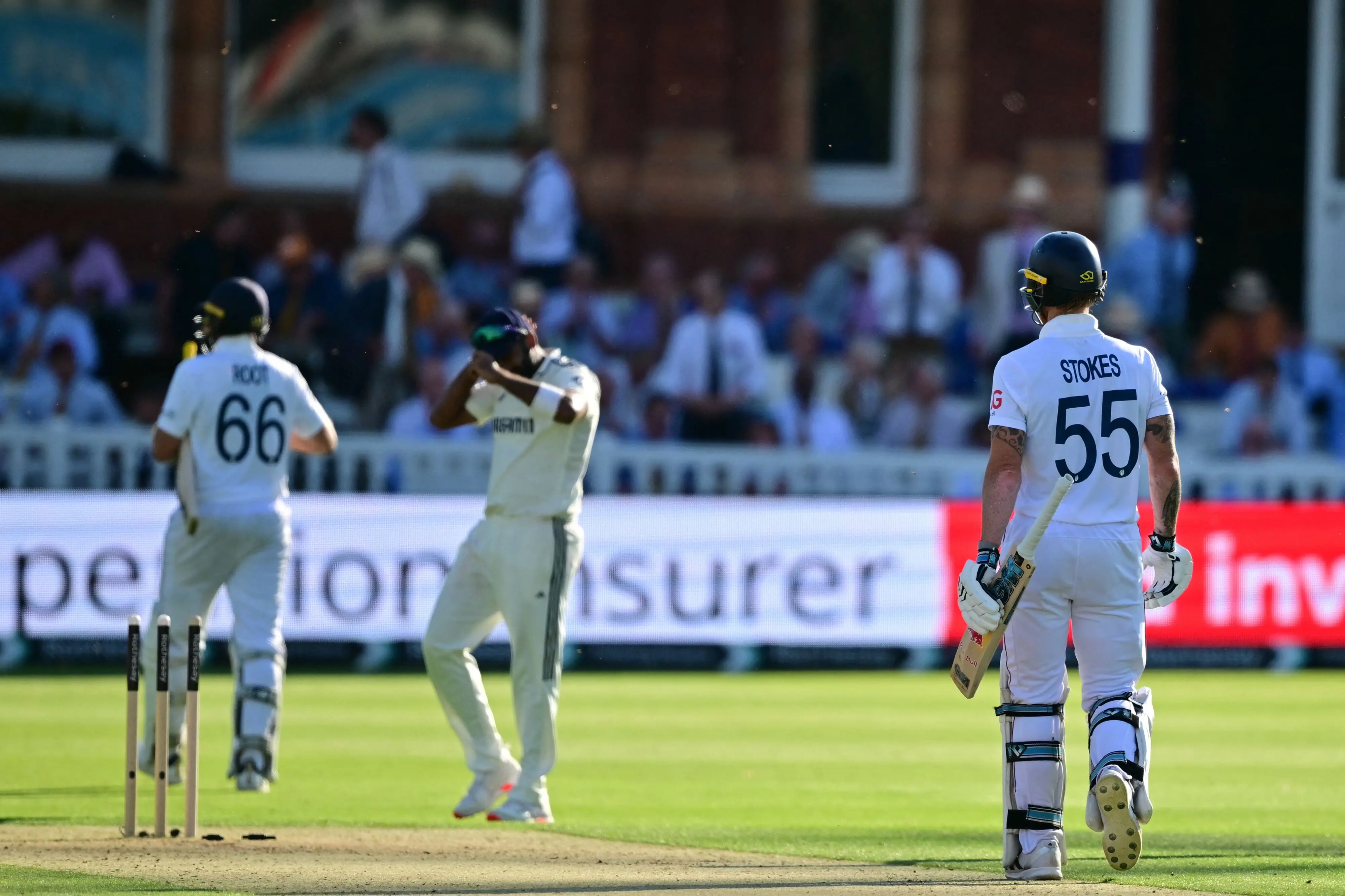 England's Joe Root (L) and England's captain Ben Stokes (R) walk off at the end of play on the opening day of the third cricket test match between England and India at Lord's cricket ground | Photo: Ben Stansall/AFP