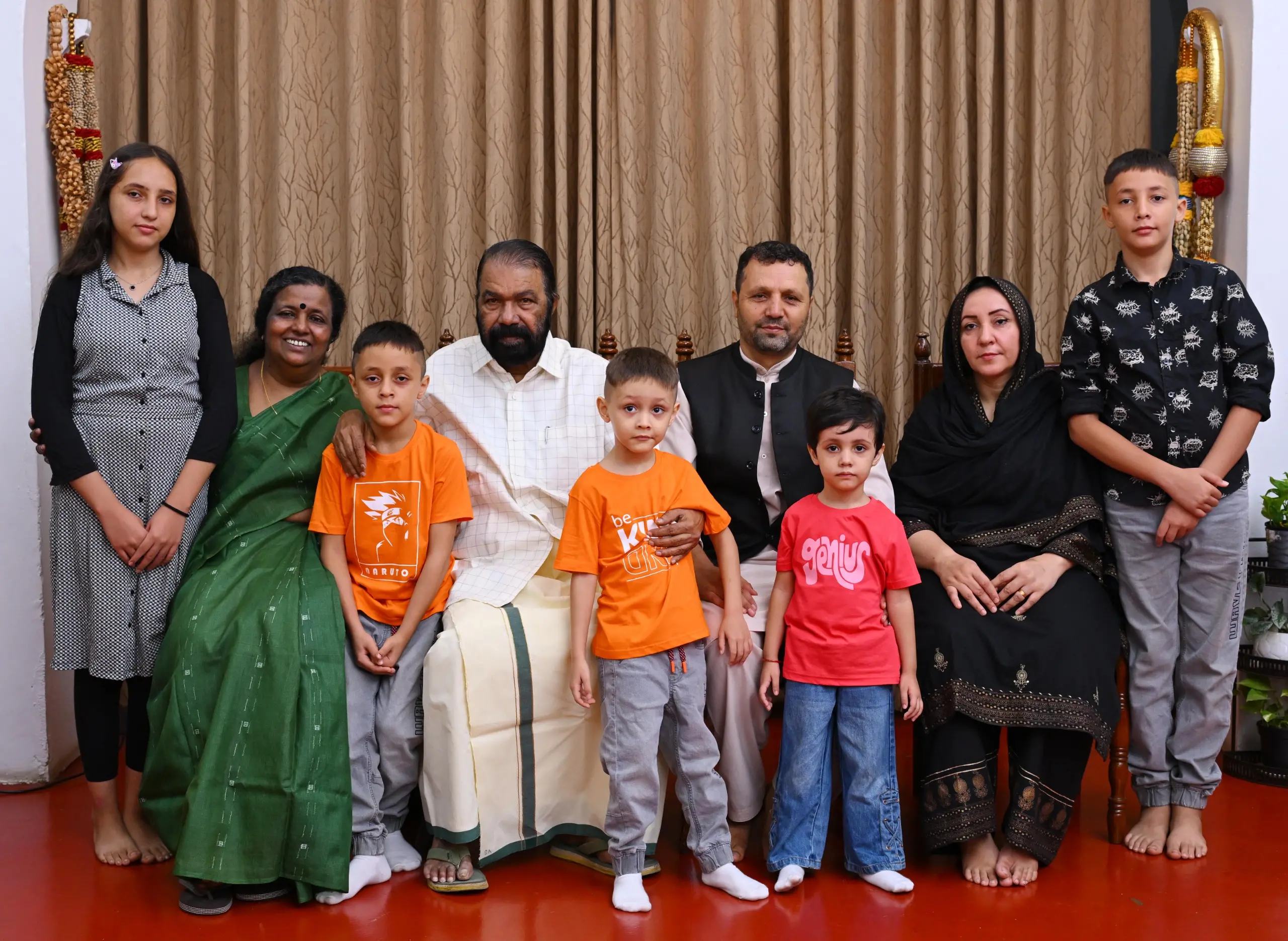 General Education Minister V Sivankutty and his wife R. Parvathy Devi pose for a photograph with the Afghan family at his official residence | Photo: Mathrubhumi