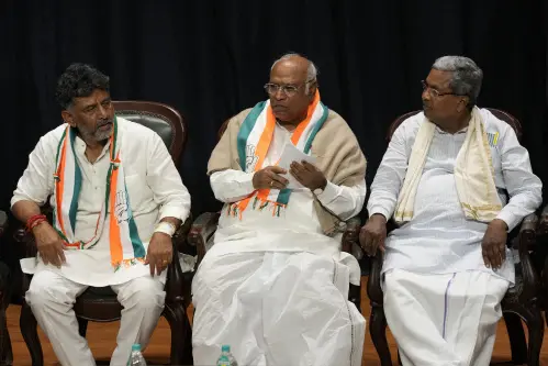 Congress party president Mallikarjun Kharge, center, flanked by\u00A0D. K. Shivakumar, left, and senior leader Siddaramaiah