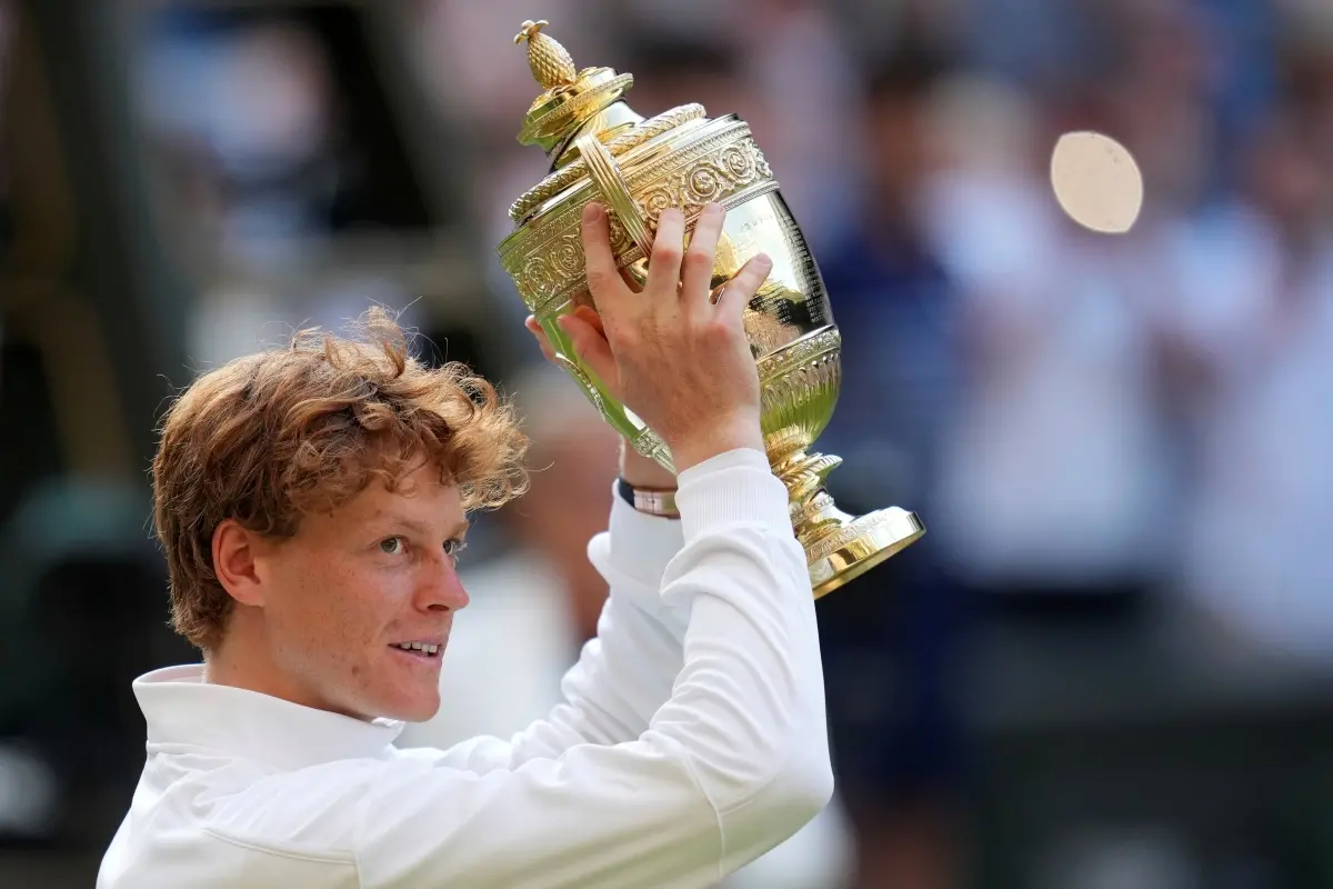 Italy's Jannik Sinner celebrates with the trophy after beating Carlos Alcaraz of Spain to win the men's singles final at the Wimbledon Tennis Championships in London. | Photo: AP