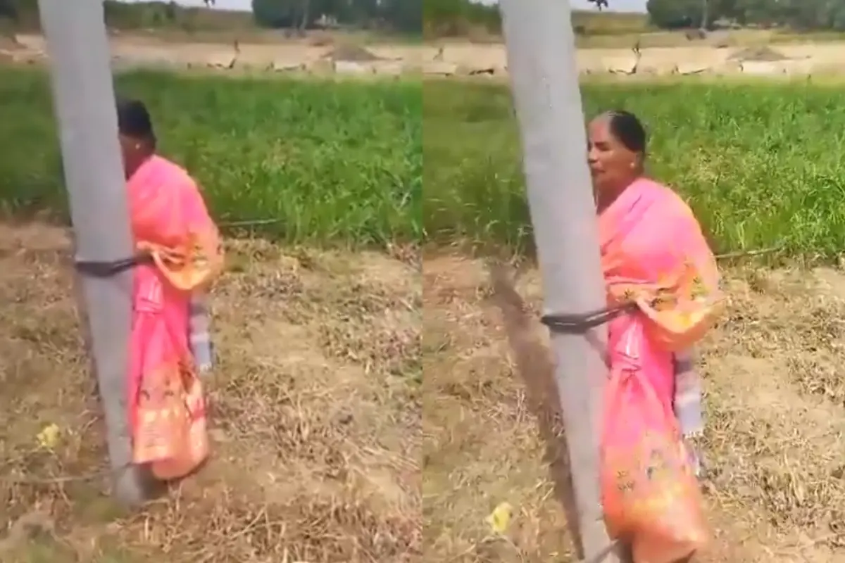 A screengrab of the video showing a woman tied to an electrical pole