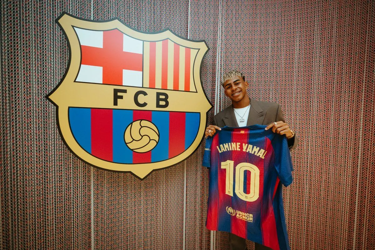 Barcelona's Spanish forward Lamine Yamal poses holding his new #10 jersey at the Camp Nou | Photo: @FCBarcelona/X