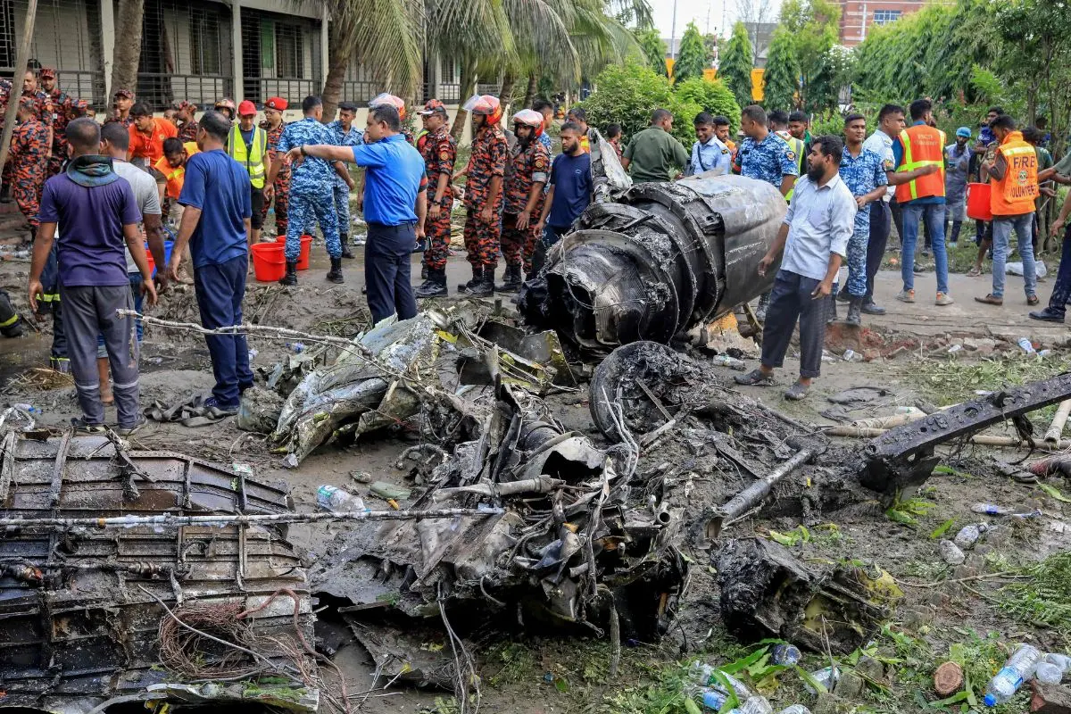 Bangladesh's fire service and security personnel conduct a search and rescue operation after an Air Force training jet crashed into a school in Dhaka | Photo: AFP