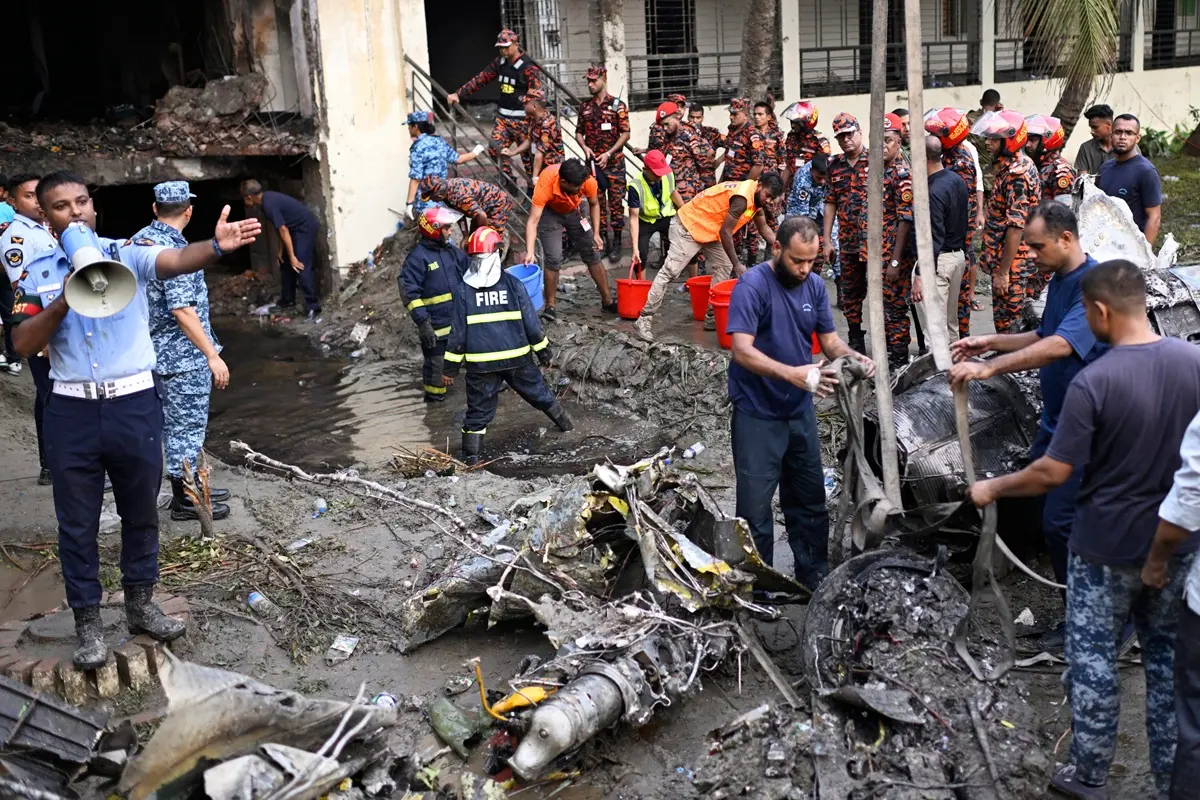 Firemen work at the site of a Bangladesh Air Force training aircraft that crashed into a school campus shortly after takeoff in Dhaka | Photo: AP