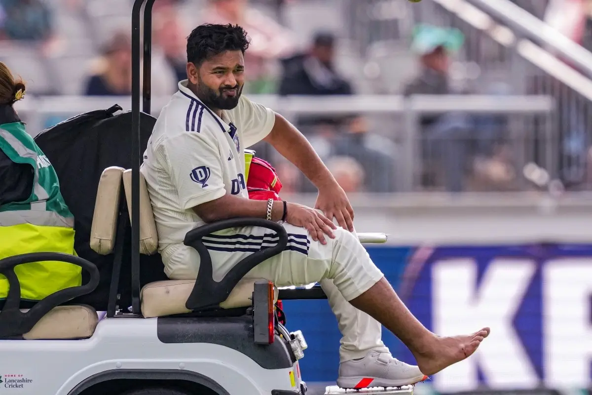 India's Rishabh Pant grimaces in pain as he is being taken off field after an injury on day one of the fourth test cricket match between India and England