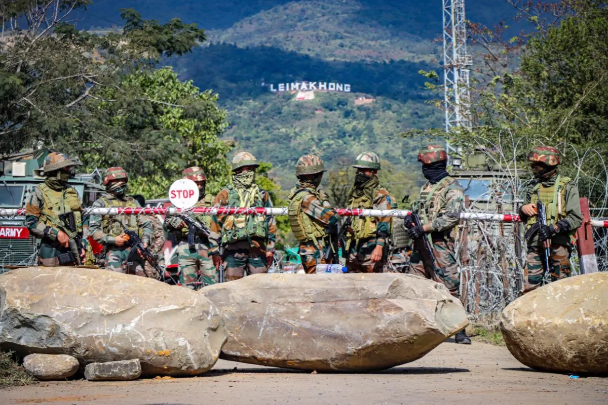 File Photo: Indian army personnel stand guard near razor wire barricades outside the Leimakhong Army Camp blocked by demonstrators with large rocks during a protest after a man from the Meitei community who worked at the camp allegedly remained missing, in Imphal West on November 26, 2024 | AFP