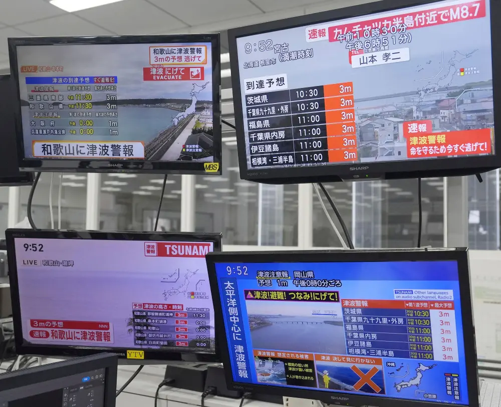 TV shows news flash after a powerful earthquake in Russia's Far East prompted tsunami warnings in parts of Japan | AP